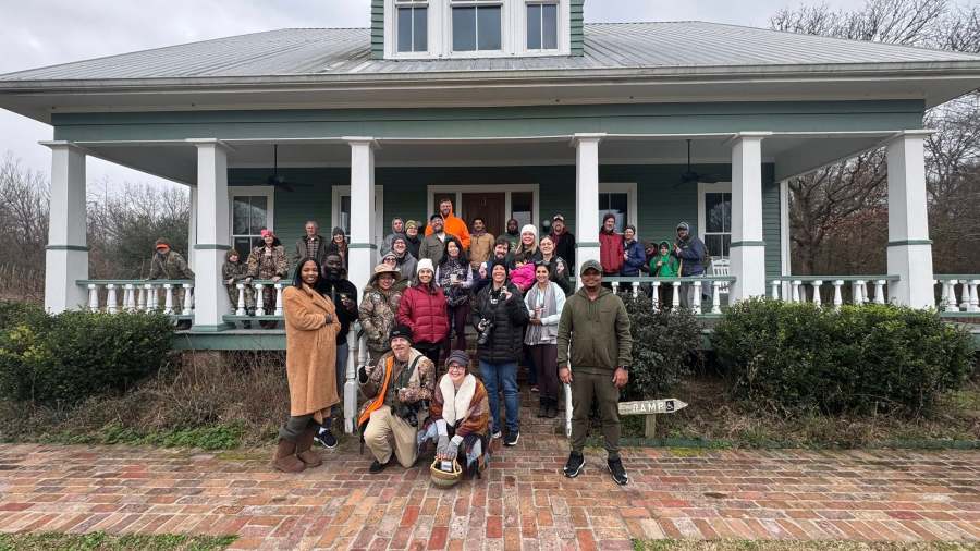 People gathered in front of Black Bayou Lake NWR Visitors' Center for a guided Nature Hike